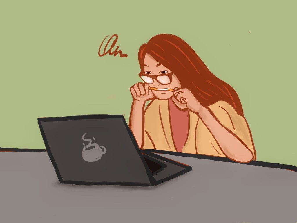 Person intensively focusing, bitting her pencil, and sitting in front of her computer.